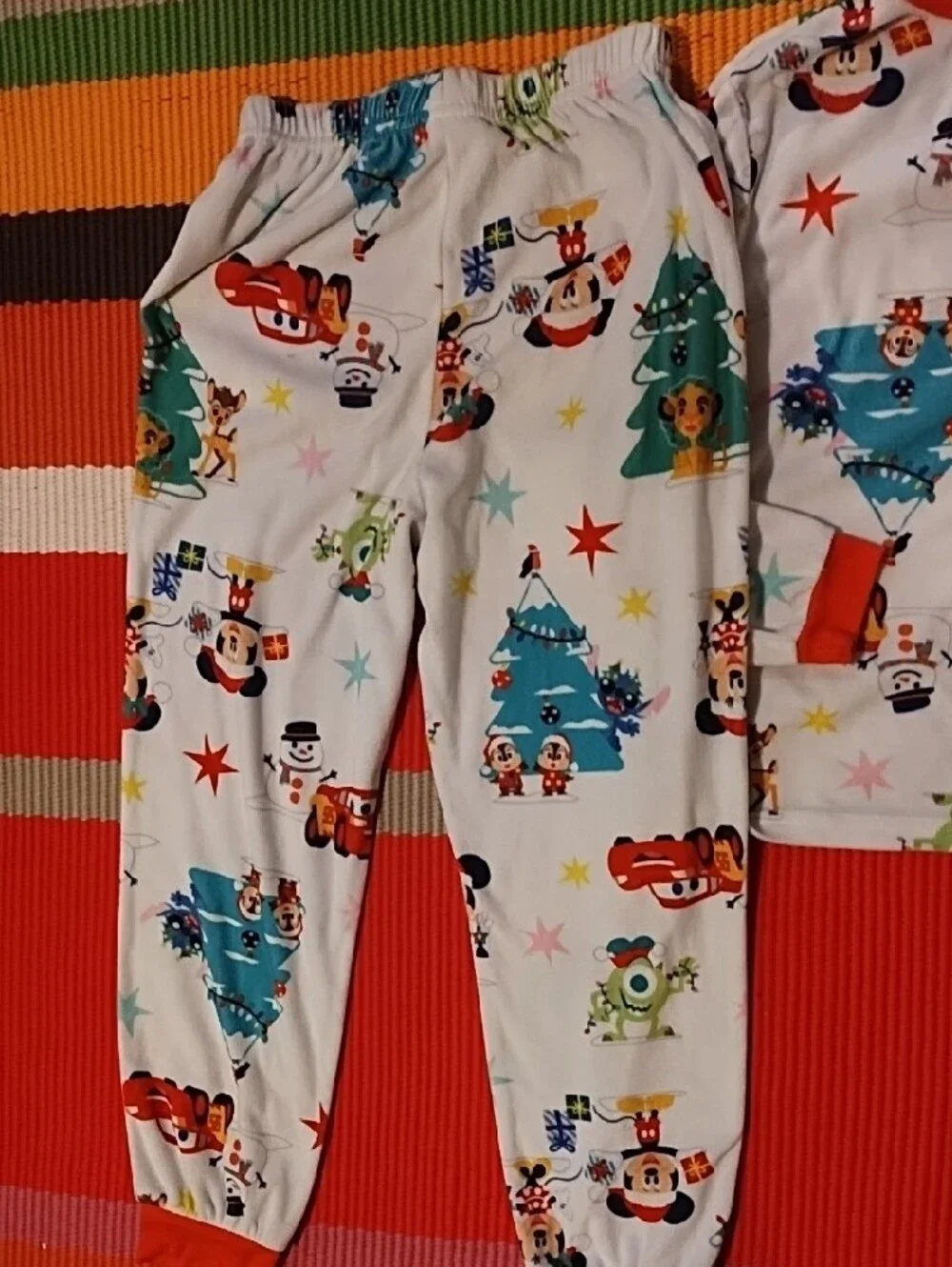 Disney Kids Holiday Pajama Set - White with Red Accents and Multicolor Prints.
